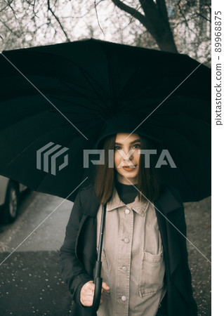 Emotional portrait, girl with umbrella, emotion - reaction to surprise, fright Emotional portrait, girl with umbrella, emotion - reaction to surprise, fright 89968875