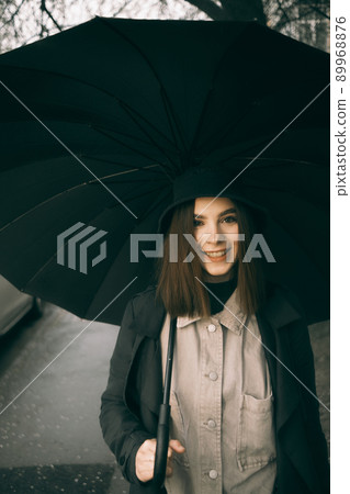 Emotional portrait, girl with umbrella, emotion - reaction to surprise, fright 89968876