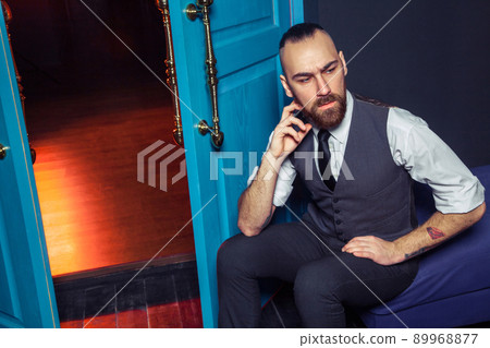 handsome fashion model man in suit model posing in the room handsome fashion model man in suit model posing in the room 89968877