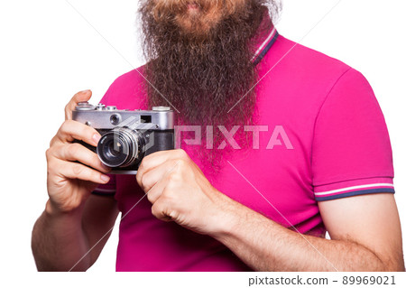 The portrait of bald bearded man photographer with pink t shirt holding classic camera. isolated on white background. studio shot. 89969021