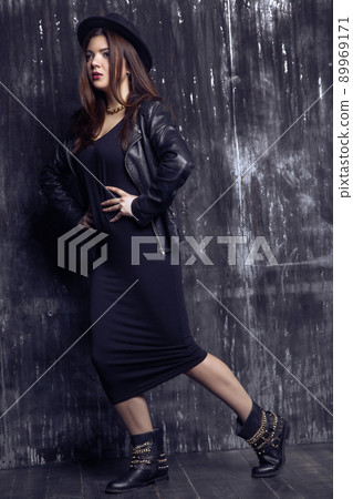 Portrait of beautiful woman model in dark dress posing and looking. Portrait of beautiful woman model in dark dress posing and looking. 89969171