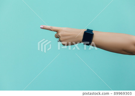 Look this! Hand finger pointing isolated on light blue background. 89969303