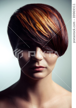 Fashion portrait of a beautiful girl with colored dyed hair, professional short hair coloring. studio shot. 89969311