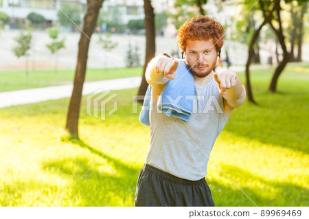 Hey you! Fitness model pointig fingers and looking at camera. Outdoor shot Hey you! Fitness model pointig fingers and looking at camera. Outdoor shot 89969469