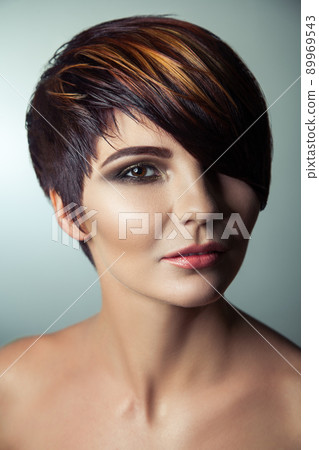 Fashion portrait of a beautiful girl with colored dyed hair, professional short hair coloring. studio shot. 89969543