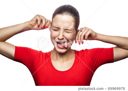 Portrait of crazy funny woman in red t-shirt with freckles. looking at camera, studio shot. isolated on white background. 89969978