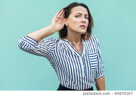 I can not hear you. Beautiful business lady . Studio shot, light blue background 89970167