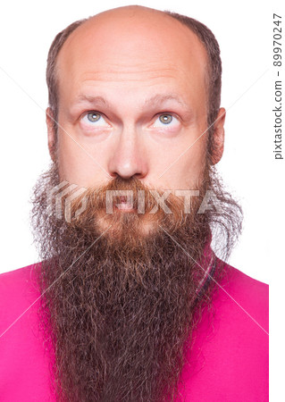 Portrait of the young bald thinking man with beard looks up. isolated on white. Portrait of the young bald thinking man with beard looks up. isolated on white. 89970247