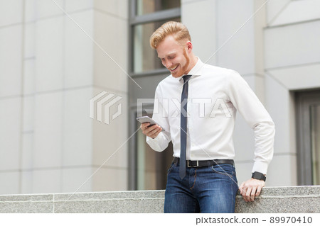 Video call. Redhead and bearded business man have a video conference in hes smart phone. Business concept. Outdoor Video call. Redhead and bearded business man have a video conference in hes smart phone. Business concept. Outdoor 89970410
