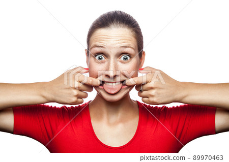 Portrait of crazy funny woman in red t-shirt with freckles. looking at camera, studio shot. isolated on white background. 89970463