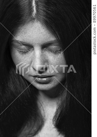 Beautiful fashion model with freckles, makeup and dark hairstyle. .Black and white photography. Beautiful fashion model with freckles, makeup and dark hairstyle. .Black and white photography. 89970561