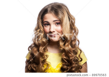 Portrait of happy girl with wavy hairstyle and yellow t shirt. studio shot isolated on white background. Portrait of happy girl with wavy hairstyle and yellow t shirt. studio shot isolated on white background. 89970563