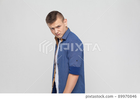 Anger boy looking seriously at camera. Studio shot Anger boy looking seriously at camera. Studio shot 89970846