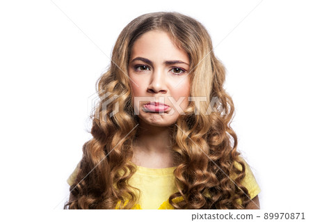 Portrait of confused girl with wavy hairstyle and yellow t shirt. studio shot isolated on white background. Portrait of confused girl with wavy hairstyle and yellow t shirt. studio shot isolated on white background. 89970871