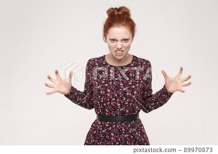 Roar! Anger ginger woman shout at camera. Bad emotions and feelings. Isolated on gray background 89970873