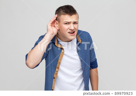 I can not hear you. Studio shot, gray background I can not hear you. Studio shot, gray background 89970923