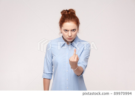 Bad emotions. Fuck sign. Redhead bussiness woman. Isolated on gray backgraund , studio shot Bad emotions. Fuck sign. Redhead bussiness woman. Isolated on gray backgraund , studio shot 89970994