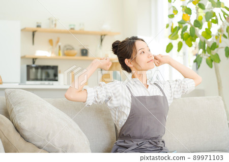 A woman relaxing on the sofa, a housewife, mom 89971103