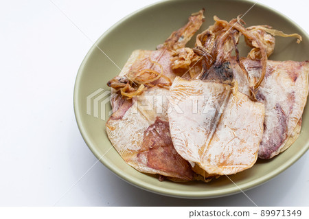 Dried squid in bowl on white background. 89971349