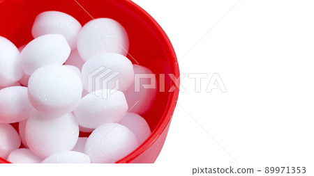 Naphthalene mothballs on blue backgrond. 89971353