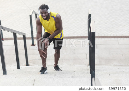 Closeup portrait unhappy man. Problems with joints in athletes after jogging. Outdoor shot, morning. Spring or summer Closeup portrait unhappy man. Problems with joints in athletes after jogging. Outdoor shot, morning. Spring or summer 89971850