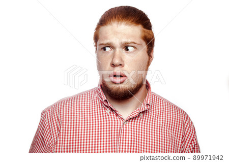 shock scared bearded readhead businessman with red shirt and freckles looking at camera. studio shot isolated on white. shock scared bearded readhead businessman with red shirt and freckles looking at camera. studio shot isolated on white. 89971942