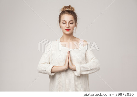 Blone young adult woman closed up, relax and pray. Studio shot Blone young adult woman closed up, relax and pray. Studio shot 89972030