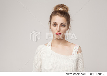 Unhappy lady puffed lips and looking sadness at camera. Indoor shot Unhappy lady puffed lips and looking sadness at camera. Indoor shot 89972042