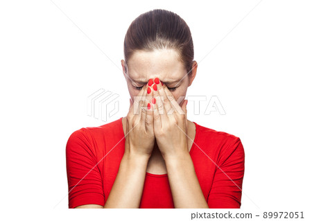 Portrait of sad unhappy crying woman in red t-shirt with freckles. closed eyes with hands, studio shot. isolated on white background. Portrait of sad unhappy crying woman in red t-shirt with freckles. closed eyes with hands, studio shot. isolated on white background. 89972051