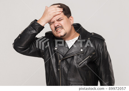 Distressed man have a problem. Touching head and have headache. Indoot shot 89972057