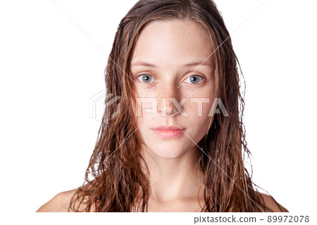 Portrait of a beautiful model with wet hair and clean skin and freckles after shower isolated on white background. 89972078