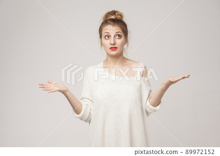 I don't know! Puzzled blonde woman looking up. Studio shot I don't know! Puzzled blonde woman looking up. Studio shot 89972152