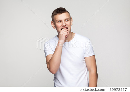 Choosing. Creativity boy looking up and thinking. Studio shot, gray background. 89972357