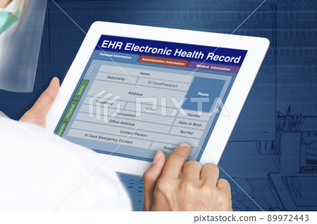 Picture looking through the shoulder of female doctor working on electronic health record. 89972443