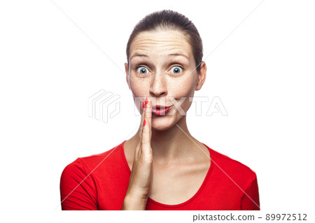 Good news, portrait of happy surprised woman in red t-shirt with freckles. looking at camera excited with big eyes, studio shot. isolated on white background. 89972512