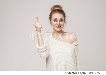 Great idea! Young adult woman finger up. Idea sign. Studio shot 89972513