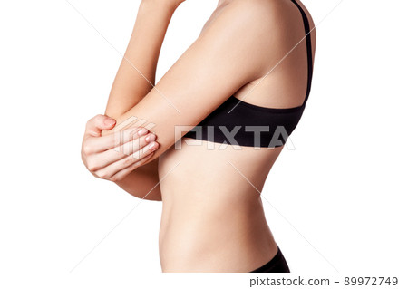Closeup view of a young woman with elbow pain on white background. 89972749
