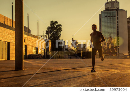 Aged sportsman running on country road, healthy inspirational fitness lifestyle, sport motivation speed interval training. Runner jogging training and doing workout exercising power walking outdoors 89973004