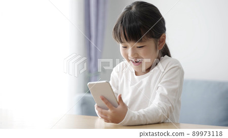 Girls using smartphones Girls using smartphones 89973118