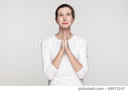 Religion concept. Prayer girl. Studio shot,isolated on gray background Religion concept. Prayer girl. Studio shot,isolated on gray background 89973247