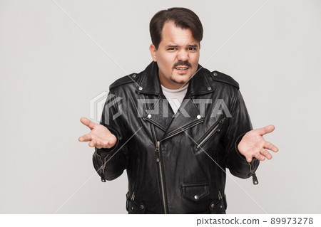 What? Not sure, answer concept. Brutal man looking at camera. Studio shot What? Not sure, answer concept. Brutal man looking at camera. Studio shot 89973278