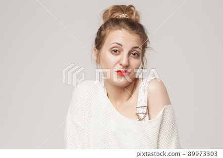I don't know! Disinterest blonde woman looking up. Studio shot I don't know! Disinterest blonde woman looking up. Studio shot 89973303