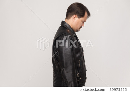Side view man with mustache, unhappy and crying adult man and looking down. Studio shot Side view man with mustache, unhappy and crying adult man and looking down. Studio shot 89973333