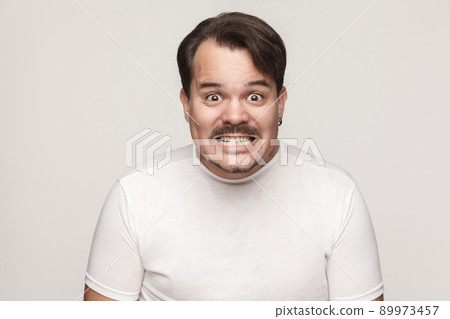 Agressive man shout at camera. Wild emotions and feelings. Isolated on gray background 89973457