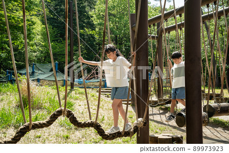 Asian elementary school students playing athletics Asian elementary school students playing athletics 89973923