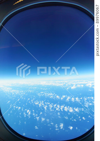Scenery seen from the inside of an airplane: Aerial view from high altitude Scenery seen from the inside of an airplane: Aerial view from high altitude 89976067