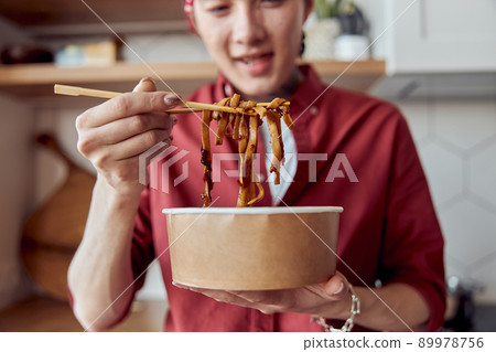 Happy Asian man going to eat noodles with chopsticks 89978756