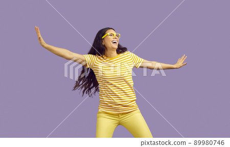 Happy young woman funny rejoicing and having fun isolated on pastel purple backgrounds. Happy young woman funny rejoicing and having fun isolated on pastel purple backgrounds. 89980746