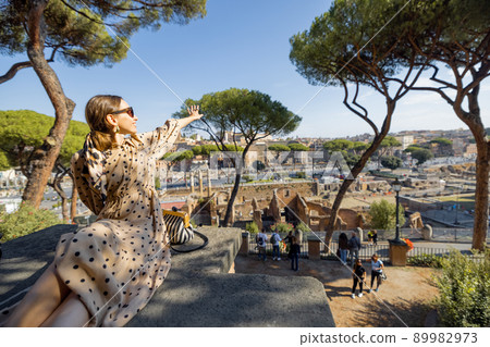Woman enjoying beautiful view from above on the old centre of Rome 89982973