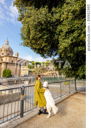 Woman walks with her dog in the centre of Rome Woman walks with her dog in the centre of Rome 89982995